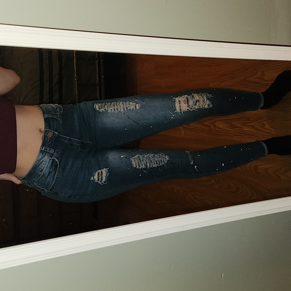 Faded, ripped and paint splattered skinny jeans